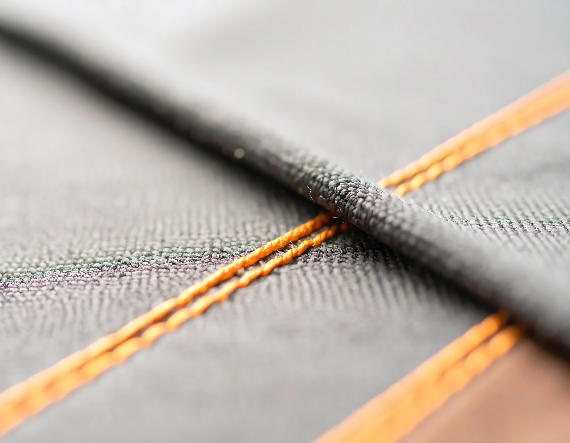 dense metallic thread embroidery on label